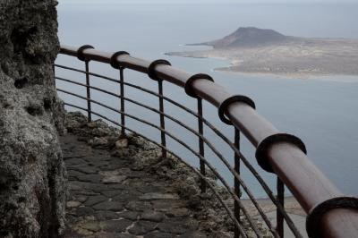 photograph “V.2016 — Lancerotte, 73” par David Farreny — www.farreny.net — Espagne, Spain, España, Canaries, Canarias, Canary, Lanzarote, Lancerotte, île, island, montagne, mountain, paysage, landscape, La Graciosa, Orzola, Mirador del roque, rambarde, guardrail, métal, metal, rocher, rock, lave, lava, pierre, stone, dallage, paving, eau, water, océan, ocean, Atlantique, Atlantic, rouille, rust, baies, bays