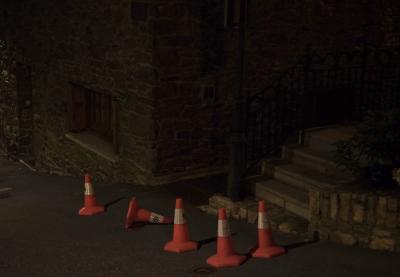 photograph “VII.2023 — At night” par David Farreny — www.farreny.net — Andorre, Andorra, Canillo, soir, evening, nuit, night, été, summer, ville, city, bourgade, town, rue, street, maison, house, pierre, stone, escalier, staircase, marches, steps, travaux, works, cônes, chantier, cones, danger, plastique, plastic, orange, bitume, blacktop, asphalte, asphalt, poteau, post, pole, métal, metal, porte, door, fenêtre, window, volets, shutters