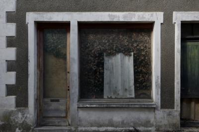 photograph “X.2016 — To go out” par David Farreny — www.farreny.net — France, magasin, shop, fermé, closed down, village, vitrine, window, porte, door, lierre, ivy, ciment, cement, crépi, roughcast, invasion, végétal, vegetal, végétation, vegetation, Occitanie, Gascogne, Gers, Manciet